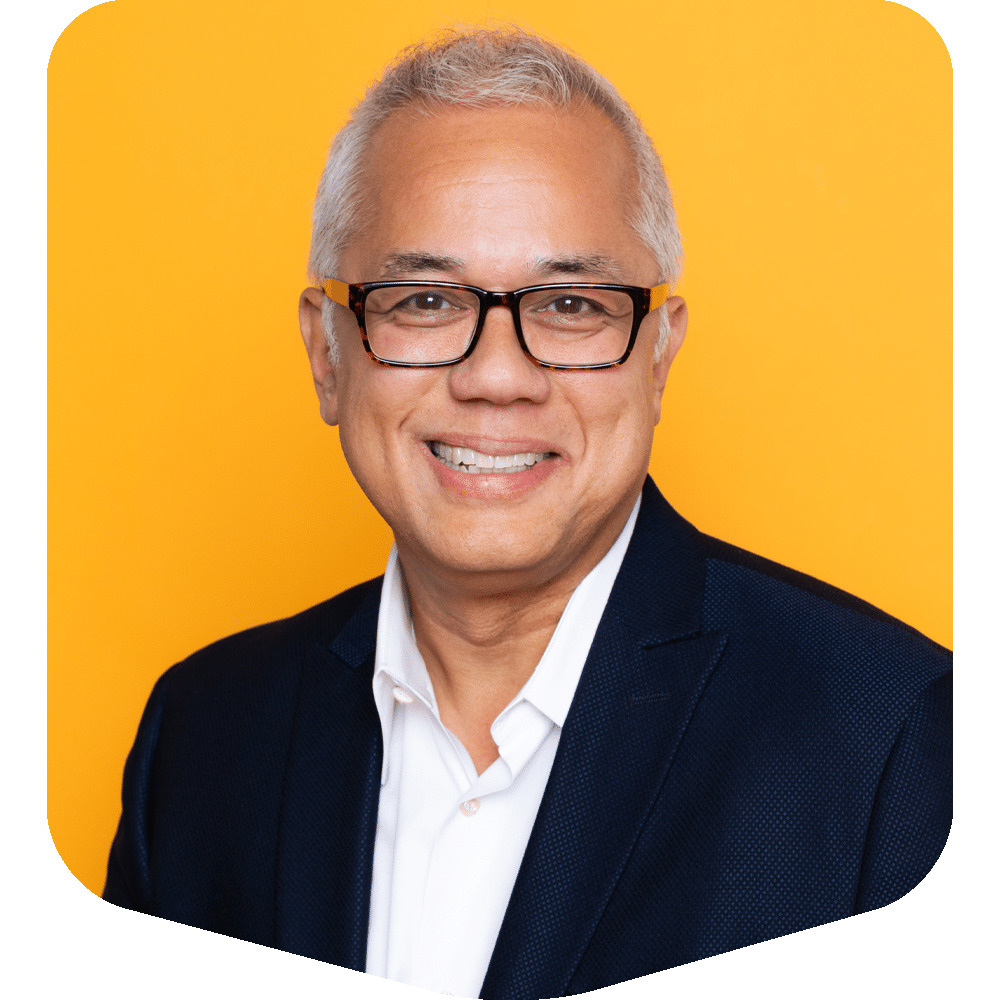 Jason Grey, smiling warmly in a professional headshot against a vibrant yellow background.