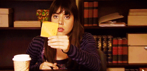 Gif of Aubrey Plaza holding up "help" sign on Parks and Recreation.